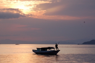 The boat for our short river trip, looking good in one of Flores' special sunsets